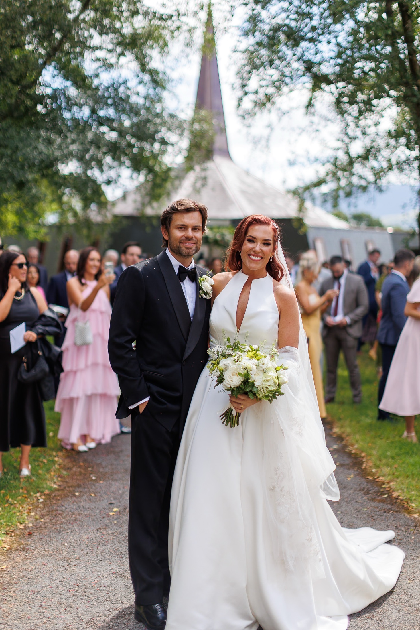 Newlyweds walking through confetti outside an Irish church