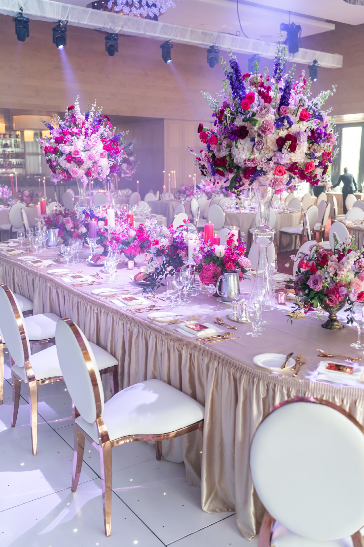 Luxury tablescape with rich floral runner and velvet chairs