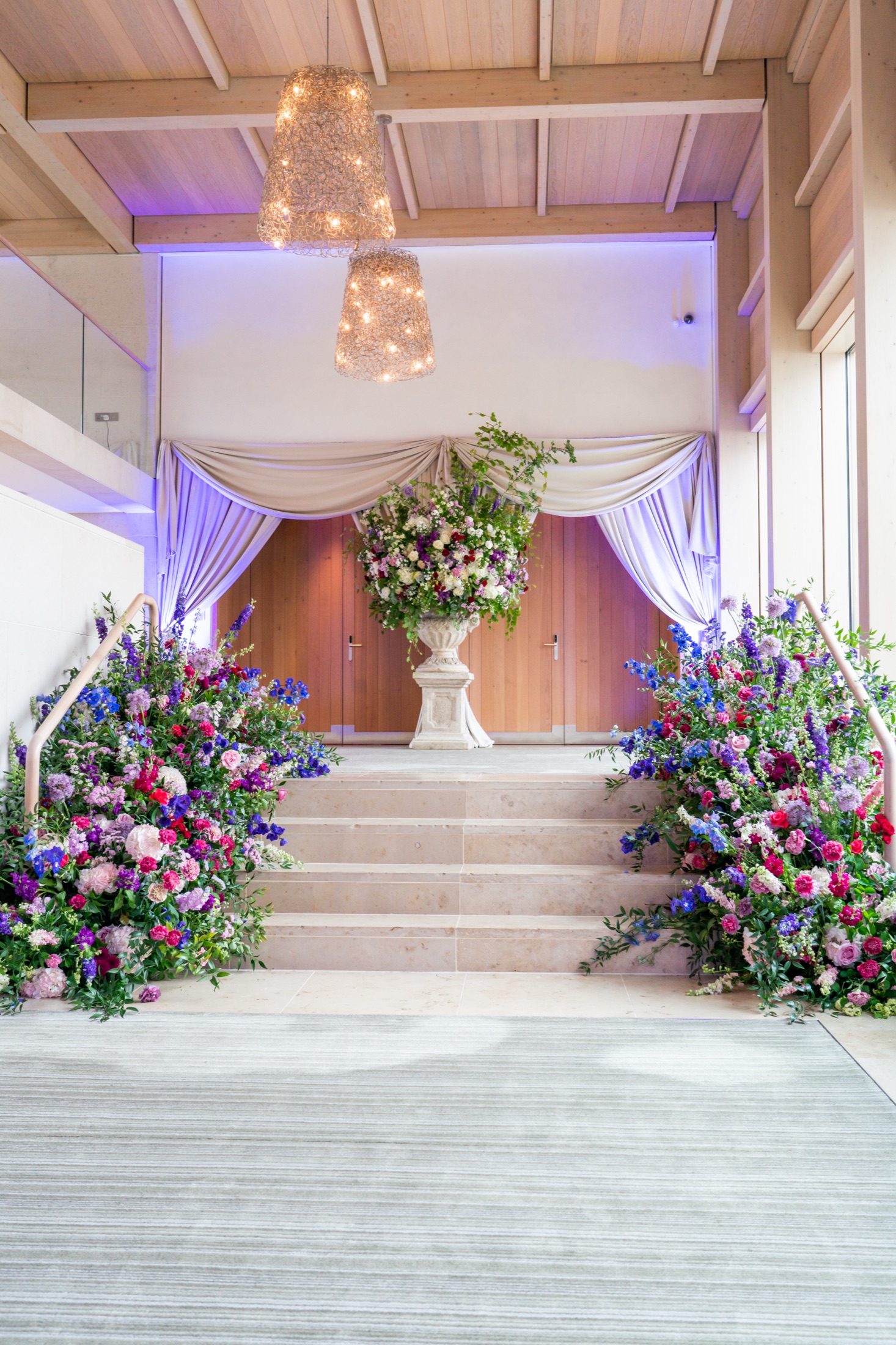 Ceremony staircase dressed with luxury floral arrangements at an Irish wedding venue